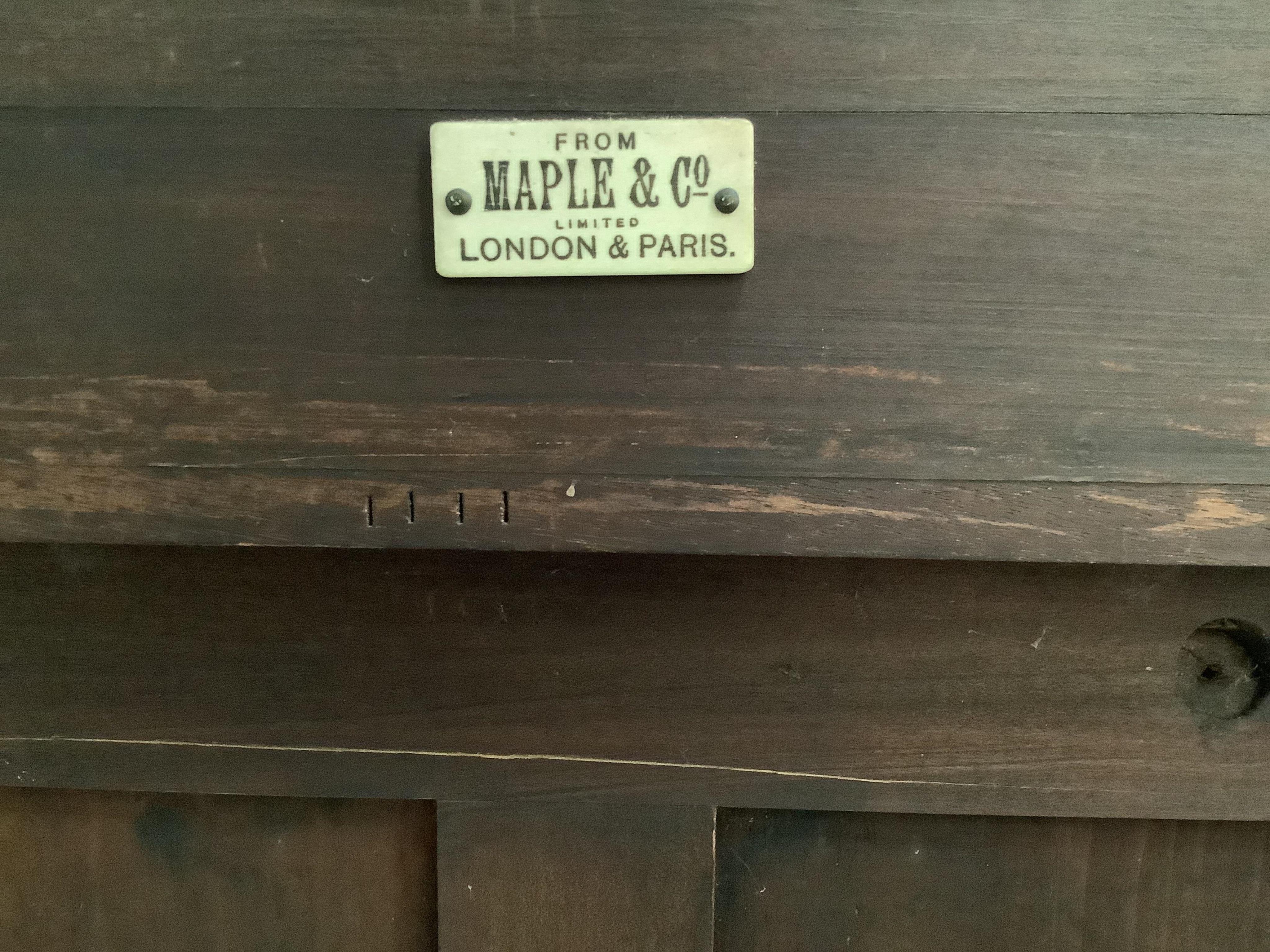 An Edwardian marquetry inlaid satinwood vitrine, bears Maple & Co. trade label, width 73cm, depth 36cm, height 148cm. Condition - good, locked, no key